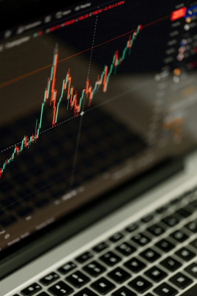 Trading chart displayed on the screen of the laptop. Stock market, trend line in a candlestick form.